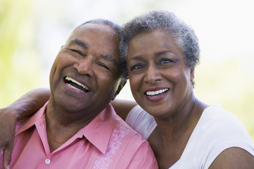 Senior couple relaxing outside A older couple from Gary enjoys confidence that comes with CertainTeed compliance and insurance