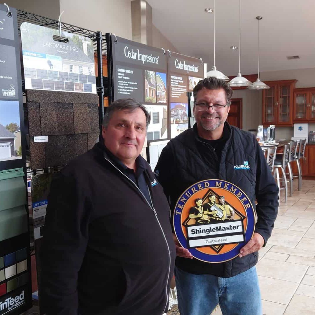Kusiak and Bob Popovich are tenured CertainTeed Contractors. Here, Dave and Bob proudly display an award