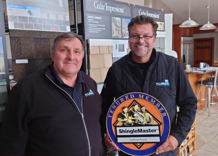 Roofers Dave Kusiak & Bob Popovich show off the CertainTeed ShingleMaster award - recognizing Kusiak as a roofing contractor in Northwest Indiana