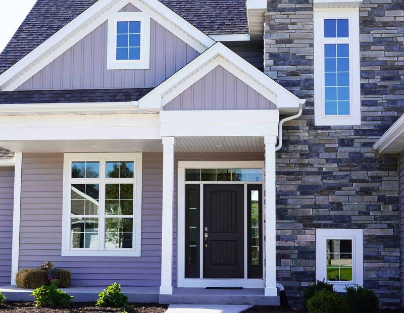 Exterior_window_blue-home-with-brick-columns-1 vinyl windows are the best replacement windows for Northwest Indiana