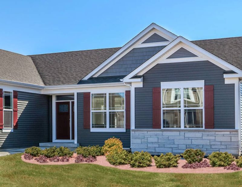 Exterior_windows_on-blue-home-with-brick-bottom-e1651187765444 Kusiak uses vinyl replacement siding to optimize looks and performance