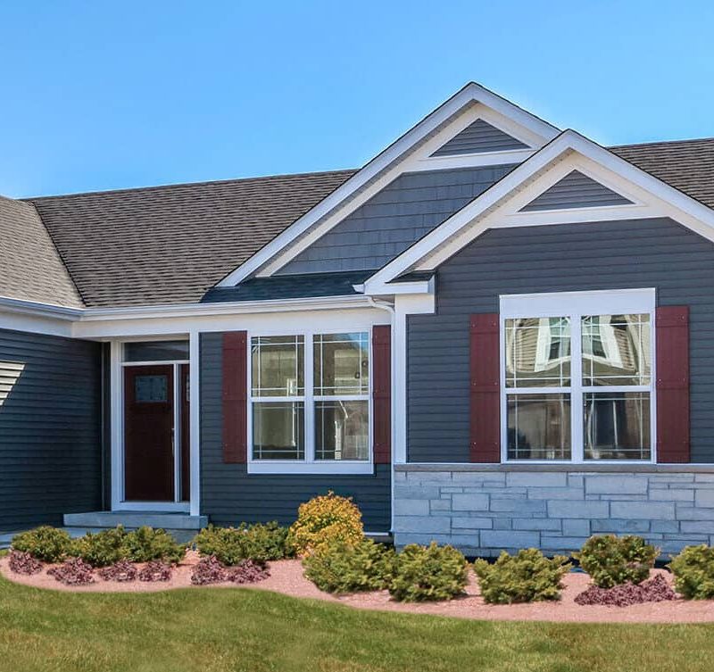 Exterior_windows_on-blue-home-with-brick-bottom-e1651187765444 Kusiak uses vinyl replacement siding to optimize looks and performance